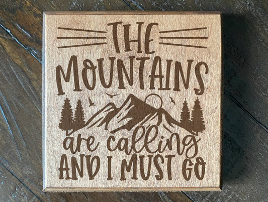 Set of four wood burned coasters with (The mountains are calling and I must go).